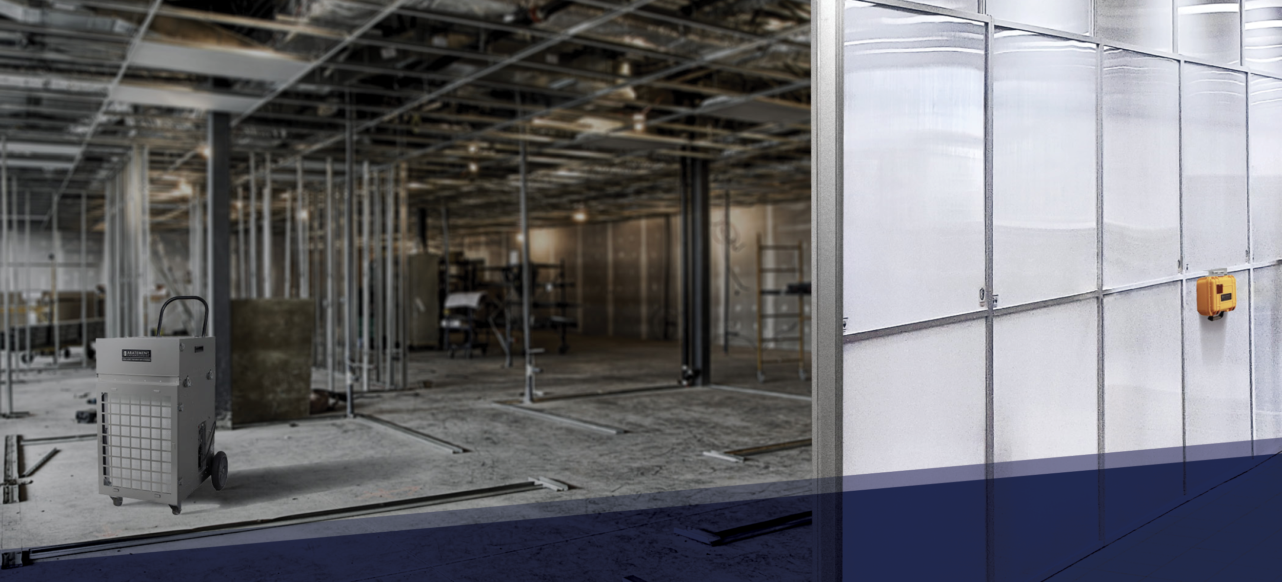 Portable air scrubber unit operating inside a commercial construction site, with SHIELD WALL® containment panels installed to maintain negative pressure and control dust in a critical environment.