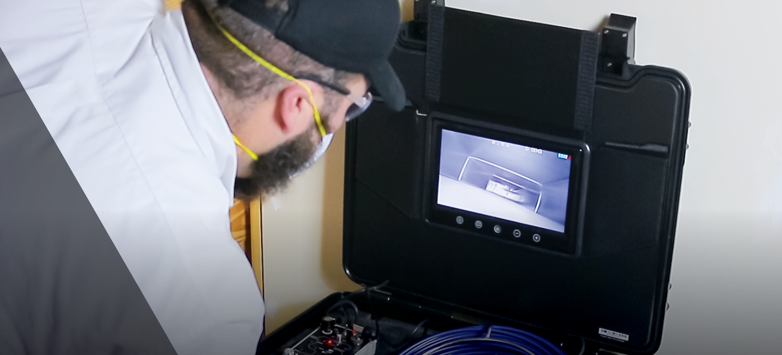 Technician inspecting ductwork using a portable video scope system with live feed displayed on a monitor. Essential tool for HVAC professionals conducting air duct assessments, identifying blockages, and verifying cleanliness after duct cleaning.
